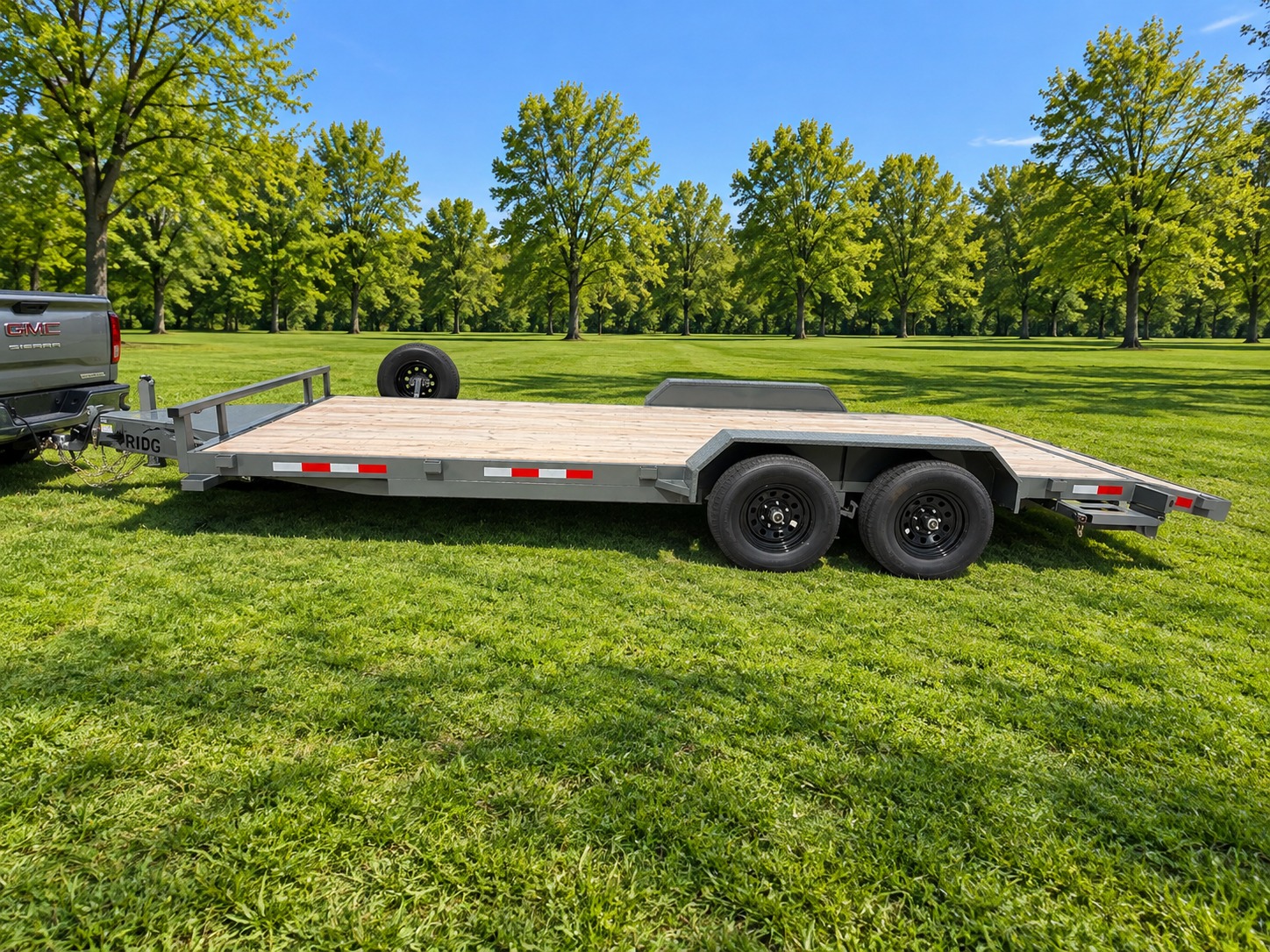 Ridgeline car hauler side view with tandem axles and spare tire